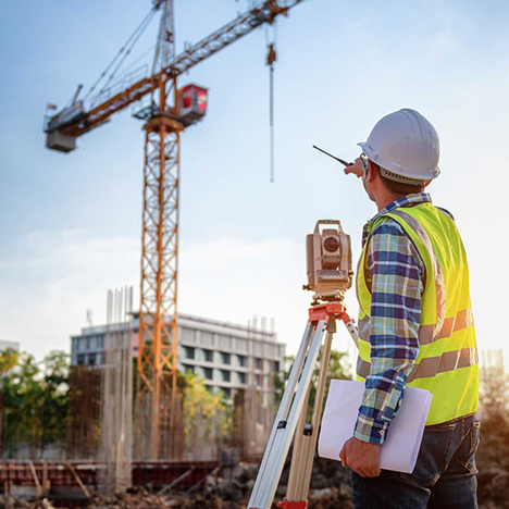 Construction surveyor on an Ontario general contracting job site